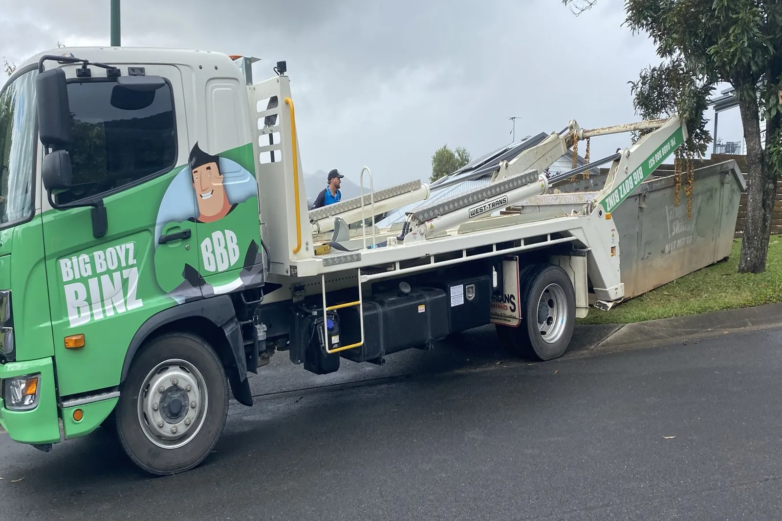Big Boyz Binz truck on a Cairns street with a skip bin on the tray